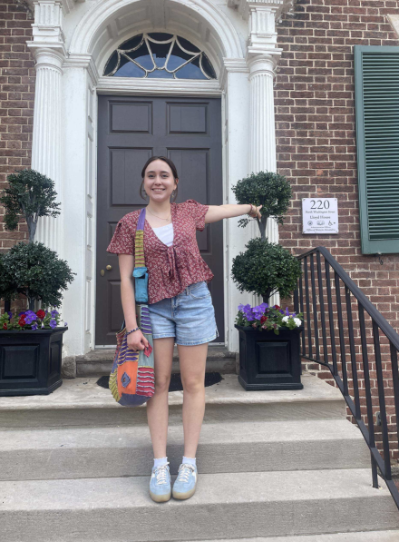 Student standing in front of administrative office building where she is interning at the Office of Historic Alexandria.